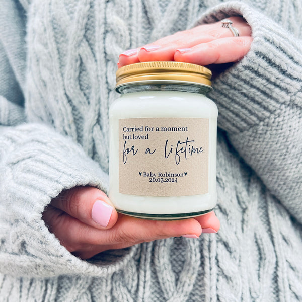 Hands holding a scented soy wax candle.