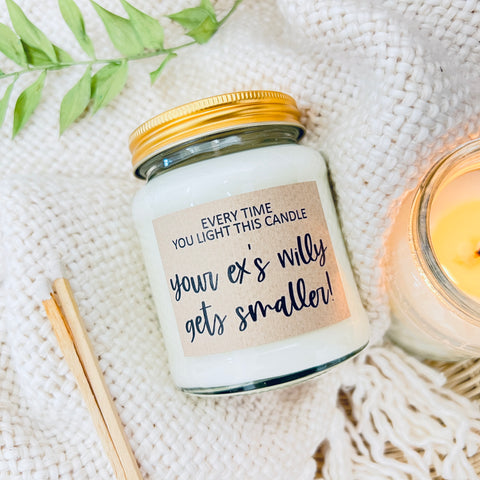 Scented Soy Wax Candle - Your Ex’s Willy Gets Smaller. A scented soy wax candle on a cozy background.