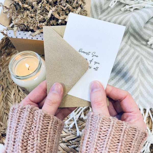 Hands holding a gift card.