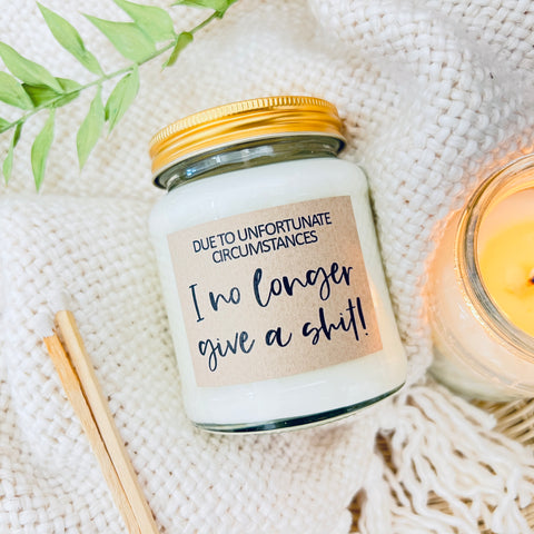 Scented Soy Wax Candle - Due to unfortunate circumstances, I no longer give a shit. A soy wax scented candle on a soft fluffy background.