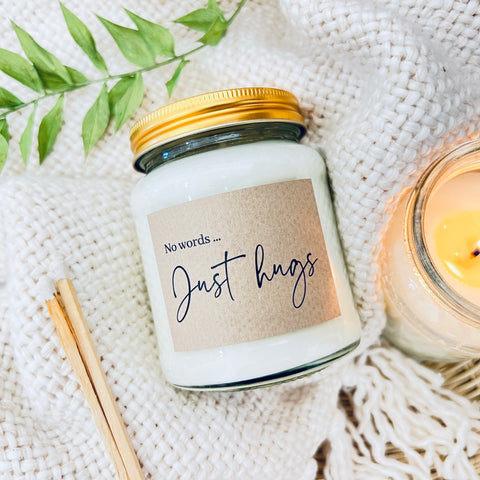 Scented soy wax candle in clear glass jar. No words, just hugs.