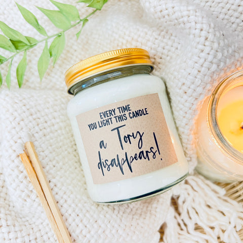 Scented Soy Wax Candle - Every time you light this candle a Tory disappears. A scented soy wax candle on a white, fluffy background.
